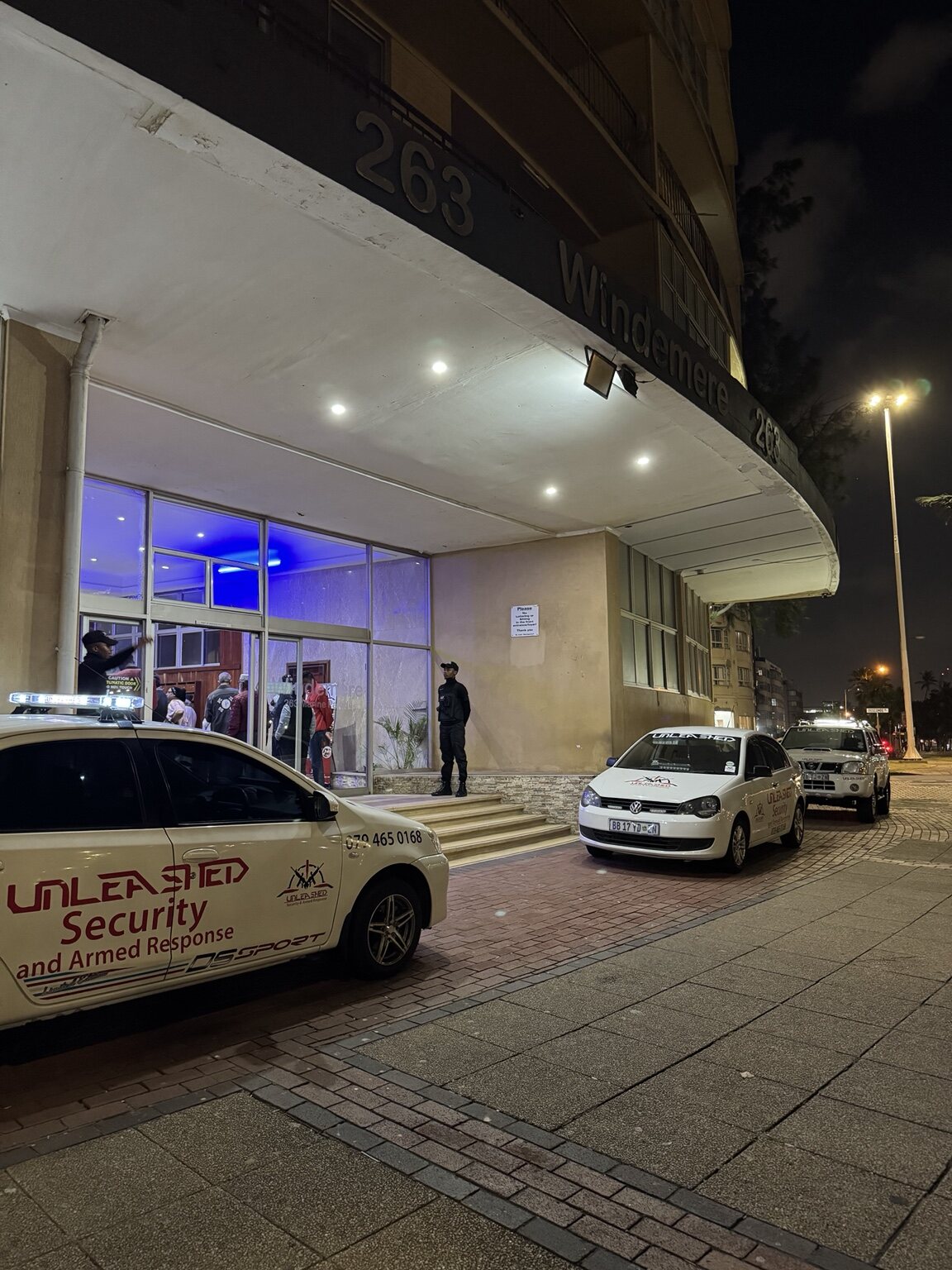 Unleashed Security office exterior with response vehicles at night