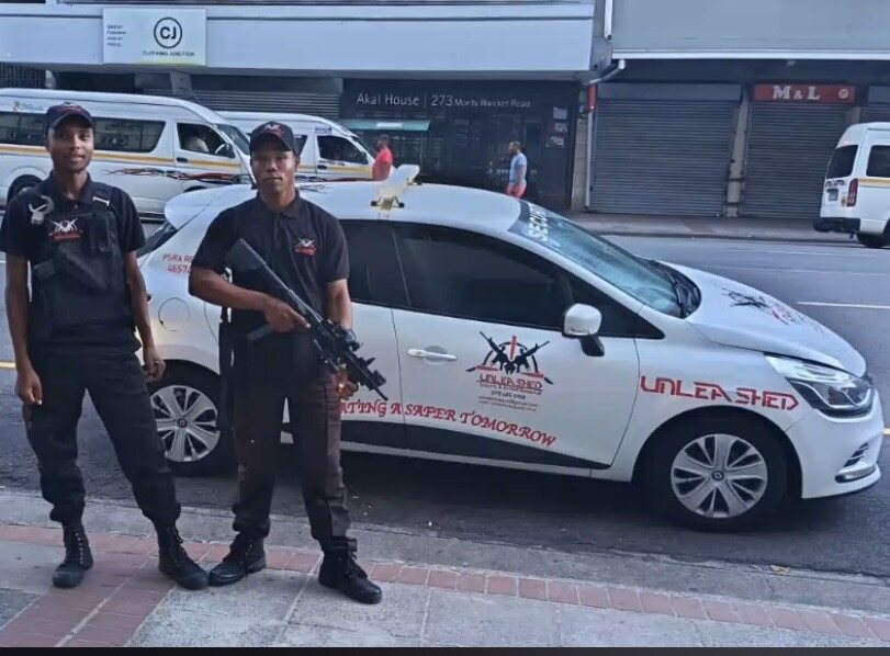 Unleashed Security tactical unit beside a marked vehicle
